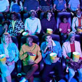 An audience of cinema goers enjoying popcorn - can you guess which of them is called Elizabeth? 