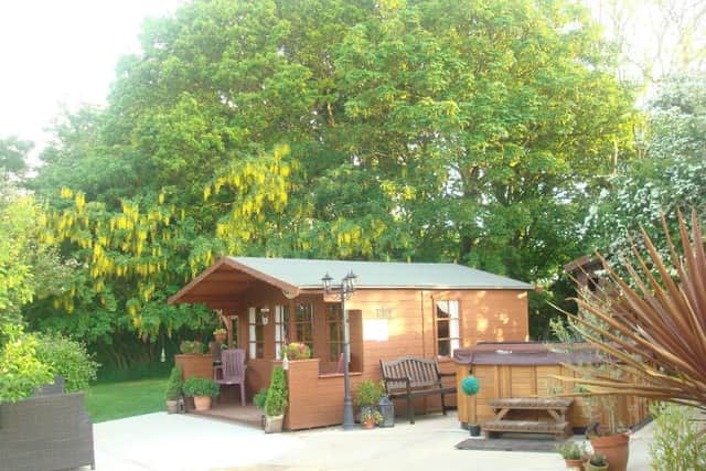 The lodge is set in an orchard and garden, complete with a large hot tub and wooden gazebo