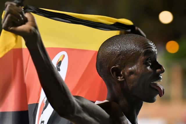Joshua Cheptegei waves an Uganda national flag as he celebrates after breaking the 10,000m track world record during the NN Valencia World Record Day at the Turia stadium in Valencia on October 7, 2020