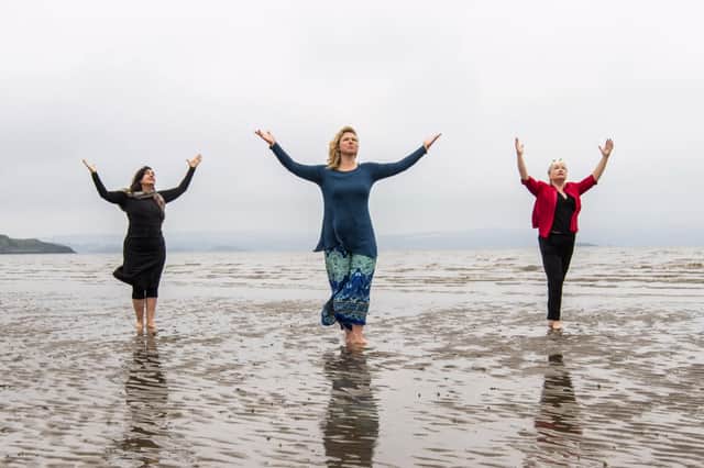 Members of the all-female cast from the show "Move", Julia Taudevin (c) Nerea Bello (L) and Mairi Morrison (r) pose for photographs at Silverknowes Beach