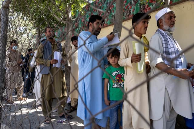 Afghans wait in long lines for hours at the passport office as many are desperate to have their travel documents ready to go on August 14, in Kabul, as tensions are high as the Taliban advance on the capital city (Paula Bronstein /Getty)