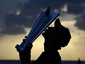 Paul Collingwood of England kisses the ICC World Twenty20 trophy on the beach after the final of the ICC World Twenty20 between Australia and England at the Kensington Oval in 2010 (Photo: Clive Rose/Getty Images)