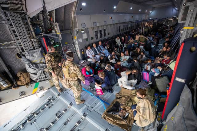 Afghan evacuees from Kabul sit inside a military aircraft as they arrive at Tashkent Airport in Uzbekistan (Photo: Marc Tessensohn/Bundeswehr via Getty Images)
