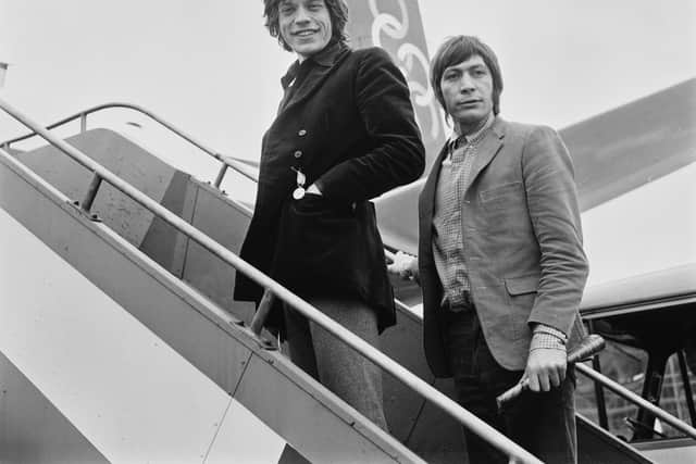 Singer Mick Jagger (left) and drummer Charlie Watts of rock group the Rolling Stones at Heathrow Airport in London, UK, April 1967 (Photo by Evening Standard/Hulton Archive/Getty Images)