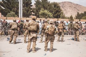 U.S. Soldiers and Marines assist with security at an Evacuation Control Checkpoint during an evacuation at Hamid Karzai International Airport (Photo by Staff Sgt. Victor Mancilla / U.S. Marine Corps via Getty Images)