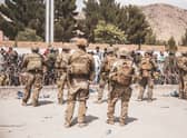 U.S. Soldiers and Marines assist with security at an Evacuation Control Checkpoint during an evacuation at Hamid Karzai International Airport (Photo by Staff Sgt. Victor Mancilla / U.S. Marine Corps via Getty Images)