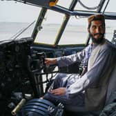 A Taliban fighter sits in the cockpit of an Afghan Air Force aircraft at the airport in Kabul (Photo: WAKIL KOHSAR/AFP via Getty Images)
