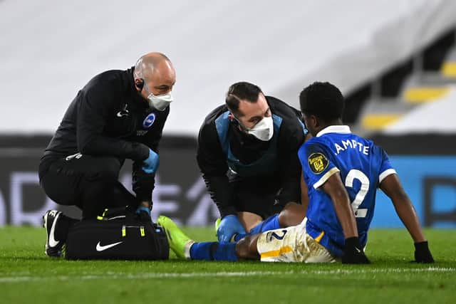 Tariq Lamptey of Brighton and Hove Albion receives medical treatment  (Photo by Mike Hewitt/Getty Images)