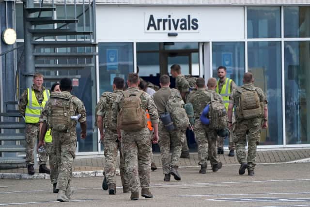 Members of the British armed forces 16 Air Assault Brigade walk to the air terminal after disembarking a Royal Air Force Voyager at RAF Brize Norton (Getty/Pool/AFP) 
