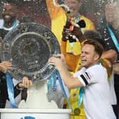Robbie Williams and Olly Murs lift the trophy after winning the Soccer Aid for UNICEF 2018 match between England and The Rest of the World at Old Trafford. (Pic: Getty)
