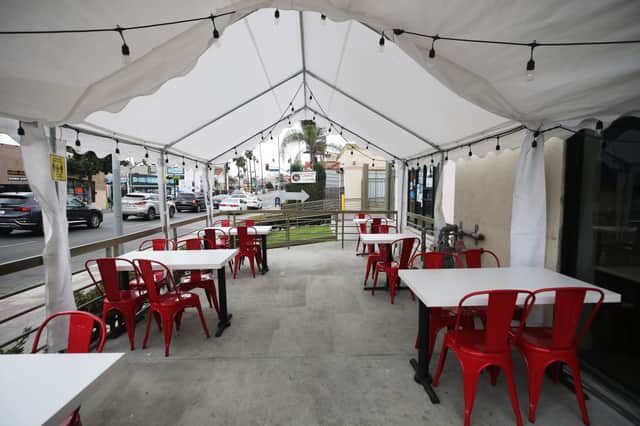 A tented area for outdoor restaurant dining stands empty (Photo: Mario Tama/Getty Images)
