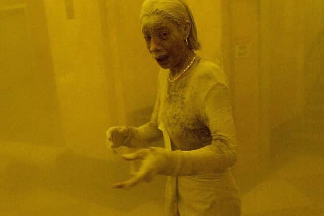 Marcy Borders covered in dust as she takes refuge in an office building after one of the World Trade Centre towers collapsed in New York (Photo: STAN HONDA/AFP via Getty Images)
