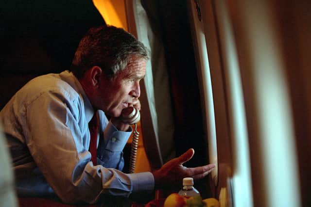 U.S. President George W. Bush speaks to Vice President Dick Cheney by phone aboard Air Force One (Photo by Eric Draper/The White House/Getty Images)
