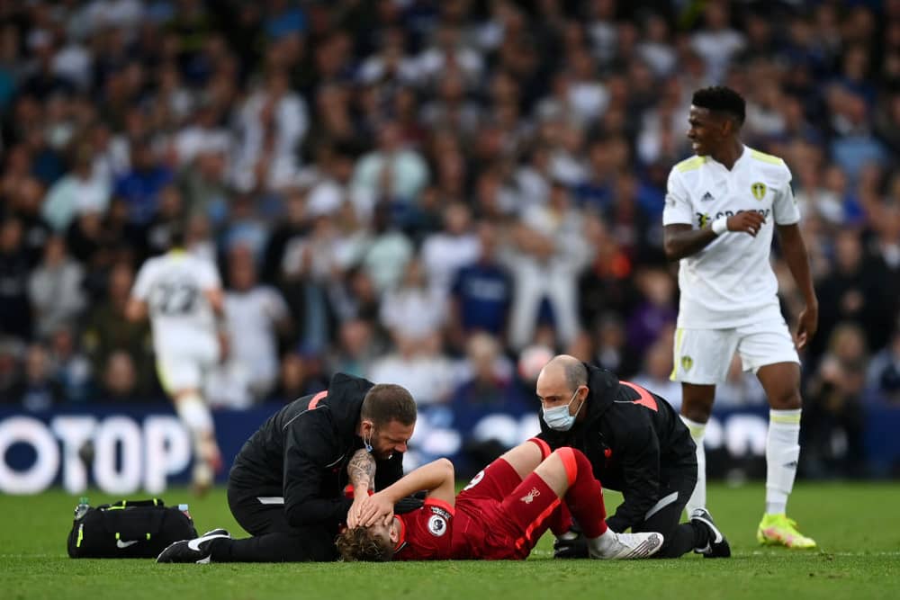 arvey Elliott of Liverpool receives medical treatment during the Premier League match between Leeds United and Liverpool at Elland Road.