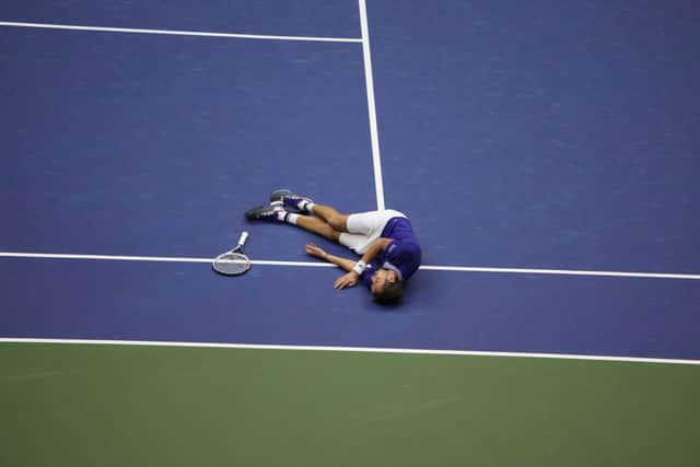 Medvedev drops to the ground in celebration of his win over Djokovic (Photo: TIMOTHY A. CLARY/AFP via Getty Images)
