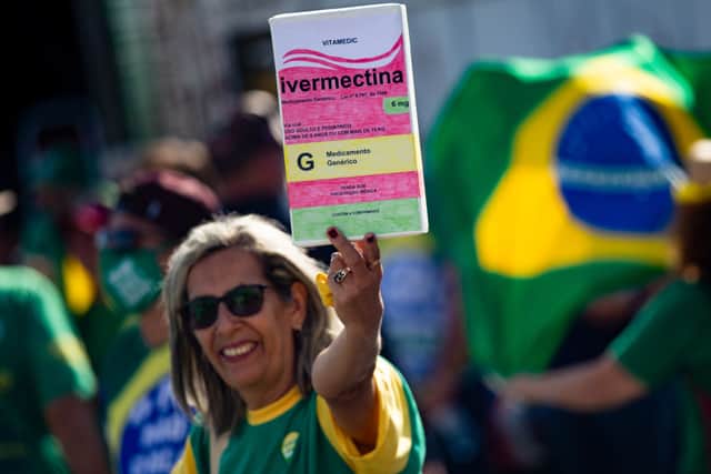 A supporter of President of Brazil Jair Bolsonaro holds a large box of box of Ivermectin (Photo: Andressa Anholete/Getty Images)