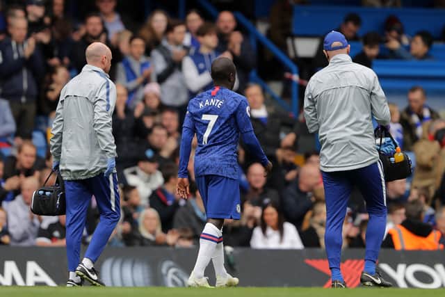 An injured N'golo Kante of Chelsea leaves the pitch during the Premier League  (Photo by Richard Heathcote/Getty Images)