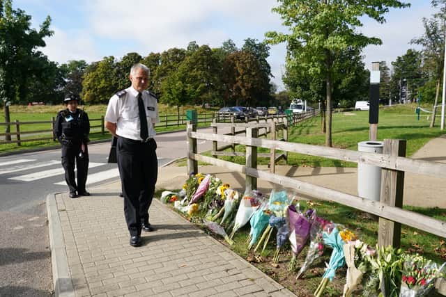 Chief Superintendent Trevor Lawry by the floral tributes at Cator Park in Kidbrooke, south London (Photo: PA)