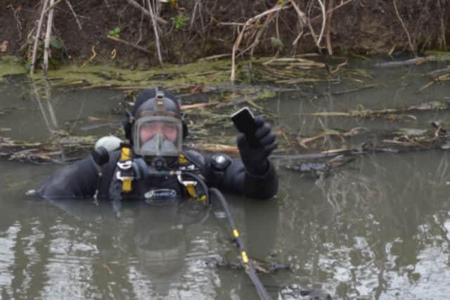 A police diver recovering a mobile phone belonging to Sarah Everard from a canal in Sandwich, Kent, where it had been thrown by Wayne Couzens. 