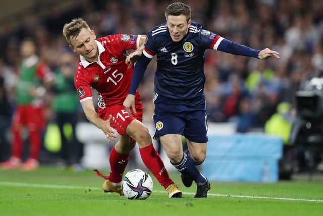 Callum McGregor of Scotland battles for possession with Ion Jardan of Moldova during the 2022 FIFA World Cup Qualifier match between Scotland and Moldova at Hampden Park on September 04, 2021