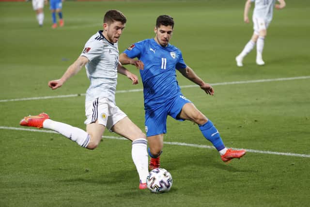 <p>Scotland’s midfielder Ryan Christie tries to cross as he is marked by Israel’s midfielder Manor Solomon during the 2022 FIFA World Cup qualifier group F football match between Israel and Scotland at Bloomfield stadium in the Israeli Mediterranean coastal city of Tel Aviv</p>