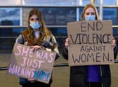 Women hold placards during a vigil held in memory of Sarah Everard on March 13, 2021 in Cardiff (Photo by Polly Thomas/Getty Images)