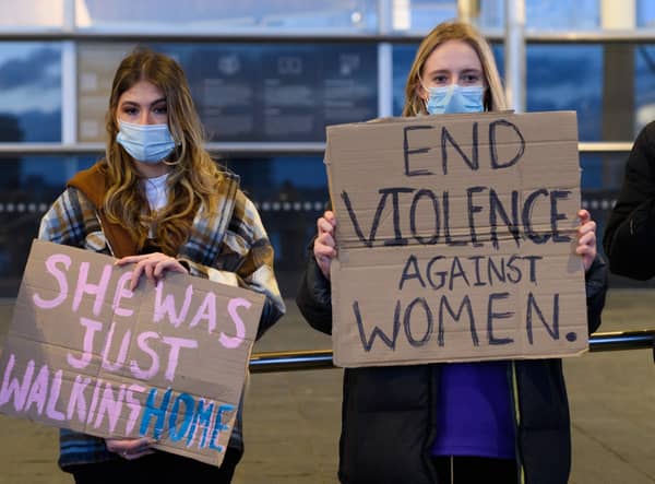 Women hold placards during a vigil held in memory of Sarah Everard on March 13, 2021 in Cardiff (Photo by Polly Thomas/Getty Images)