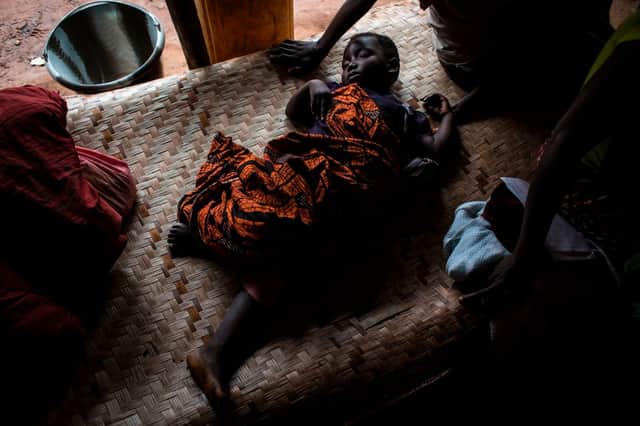A sick baby is seen at a makeshift paediatric health centre as an outbreak of malaria hit an African village (Picture: Getty Images)