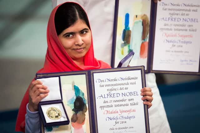 Nobel Peace Prize laureate Malala Yousafzai displays her medal and diploma during the Nobel Peace Prize awards ceremony in 2014