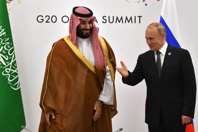 Russia's President Vladimir Putin (R) gestures toward Saudi Arabia's Crown Prince Mohammed bin Salman during a meeting on the sidelines of the G20 Summit in Osaka on June 29, 2019