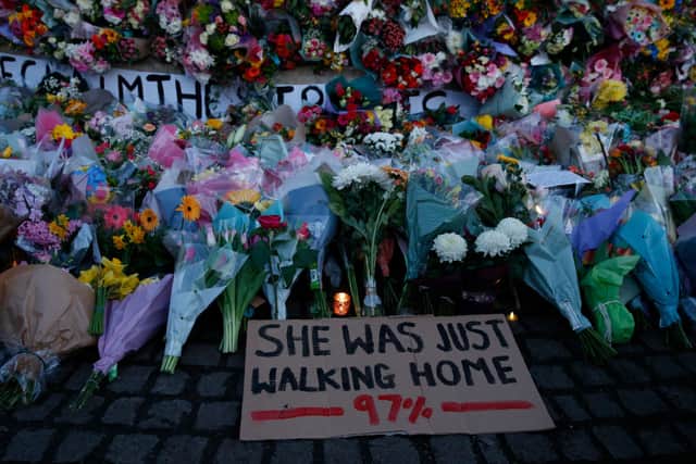 A sign saying “SHE WAS JUST WALKING HOME 97%” is seen among the flowers and candles on Clapham Common where floral tributes were placed for Sarah Everard (Photo: Hollie Adams/Getty Images)