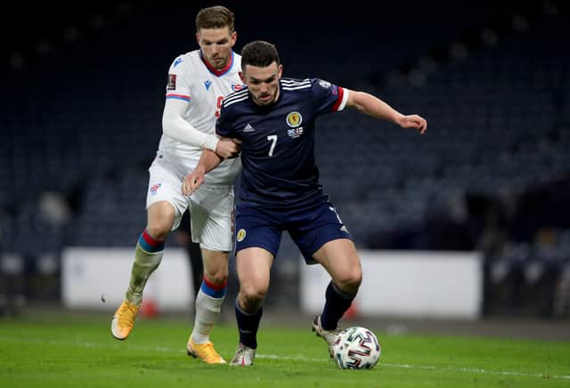 John McGinn of Scotland battles for possession with Gilli Rolantsson of Faroe Islands during the FIFA World Cup 2022 Qatar qualifying match between Scotland and Faroe Islands at Hampden Park on March 31, 2021
