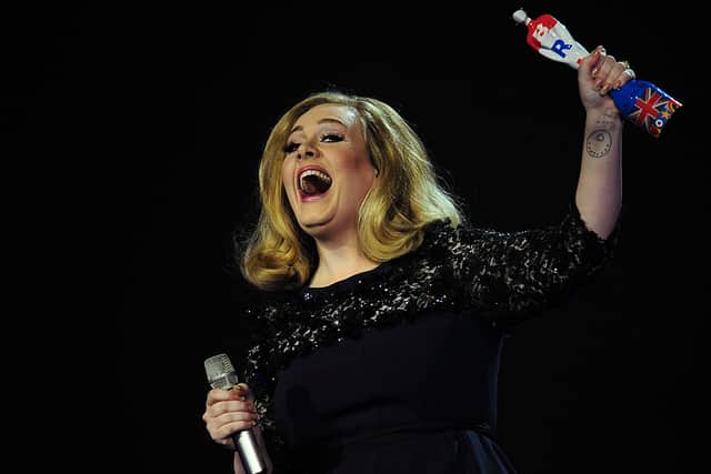 Adele celebrates with the British Album of the Year award for her album “21” at the BRIT Awards 2012 in London (Photo: LEON NEAL/AFP via Getty Images)