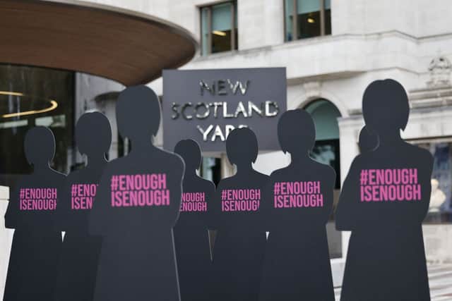 Cut-out silhouettes representing women are set up outside the Metropolitan Police headquarters New Scotland Yard in London on October 7, 2021 in an action by Refuge, the domestic abuse charity, to highlight the issue of women who have been killed by male police officers or former police officer (Photo: TOLGA AKMEN/AFP via Getty Images)