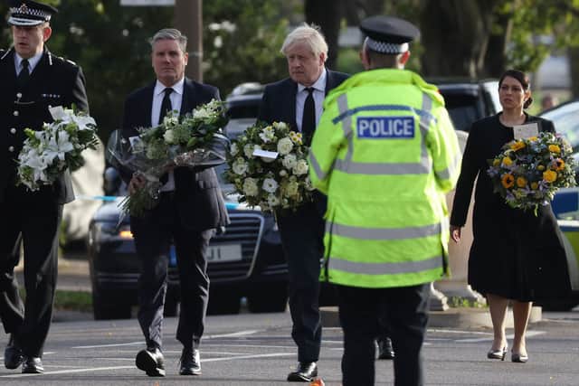 Keir Starmer, Boris Johnson and Priti Patel pay their respects at the scene of Sir David Amess’ murder (Picture: Getty Images)