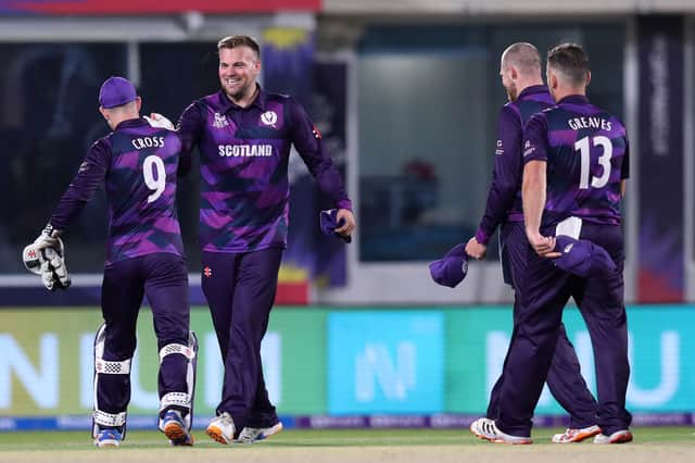 Scotland's players celebrate their win in the ICC mens Twenty20 World Cup cricket match between Bangladesh and Scotland at the Oman Cricket Academy Ground in Muscat