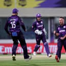 Scotland's Chris Greaves (2R) celebrates with teammates after taking the wicket of Bangladesh's Mushfiqur Rahim (not pictured) during the ICC mens Twenty20 World Cup cricket match between Bangladesh and Scotland at the Oman Cricket Academy Ground in Muscat