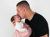Alan Barefoot with his newborn daughter. Mr Barefoot died after he was attacked, now police have launched a murder investigation.
