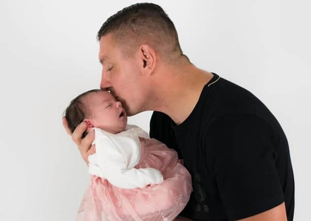 <p>Alan Barefoot with his newborn daughter. Mr Barefoot died after he was attacked, now police have launched a murder investigation.</p>