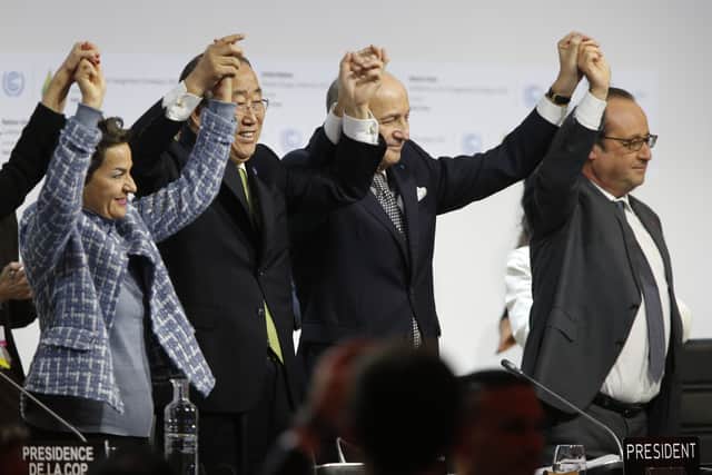 Laurent Fabius, Secretary General of the United Nations Ban Ki Moon and former French President Francois Hollande following the signing of the Paris Climate Agreement in 2015. (Credit: Getty)