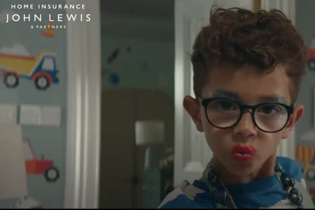 A young boy dressed in jewellery, makeup and a dress obviously destroys his house in the now-banned John lewis advert. 