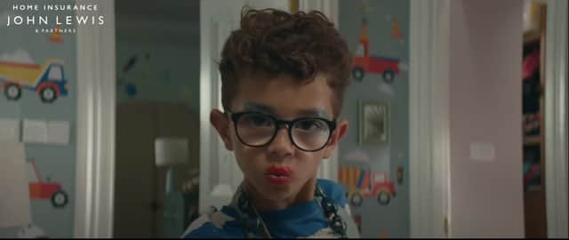 A young boy dressed in jewellery, makeup and a dress obviously destroys his house in the now-banned John lewis advert. 