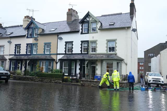 Flooded roads in Cockermouth, Cumbria, where the Met office has warned of life-threatening flooding and issued amber weather warnings as the area was lashed with "persistent and heavy rain".