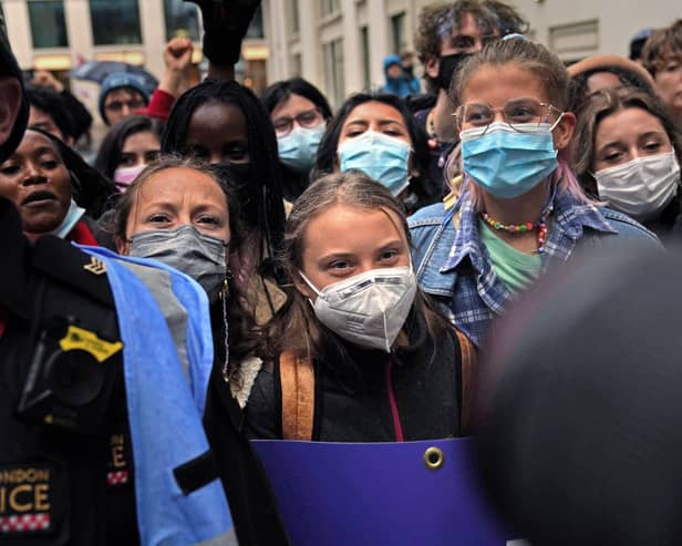 Teenage activist Greta Thunberg (centre) joins activists taking part in the Youth Strike to Defund Climate Chaos protest against the funding of fossil fuels outside Standard Chartered Bank in London. Picture date: Friday October 29, 2021. (Pic: PA)