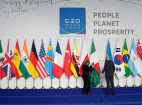 Flags being adjusted prior to a group photo of world leaders at the La Nuvola conference centre for the G20 summit (Photo: Kirsty Wigglesworth - Pool/Getty Images)