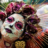 A woman takes part in the Day of the Dead parade