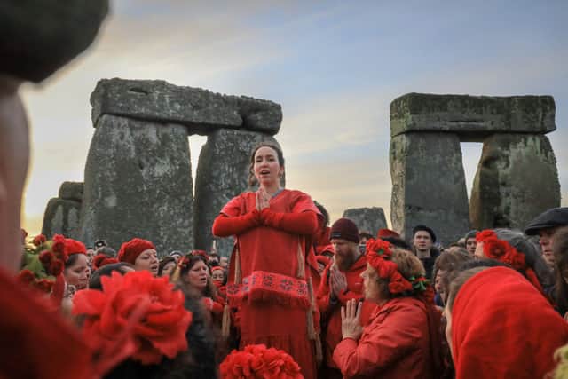Members of the Shakti Sings choir sing as druids, pagans and revellers gather in the centre of Stonehenge, hoping to see the sun rise, as they take part in a winter solstice ceremony (Photo: Matt Cardy/Getty Images)