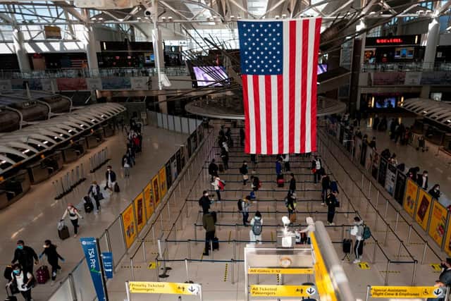 Travellers are required to wear face masks air passengers wear a mask while on board flights to the US and in airports (Photo: Getty Images)