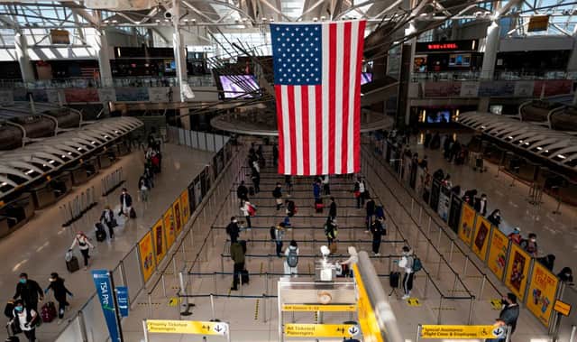 Travellers are required to wear face masks air passengers wear a mask while on board flights to the US and in airports (Photo: Getty Images)