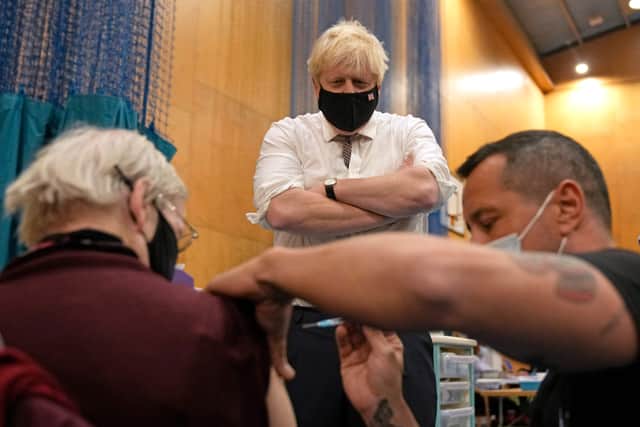 Boris Johnson visits a vaccine centre during a visit to Little Venice Sports Centre in London. (Credit: Getty)